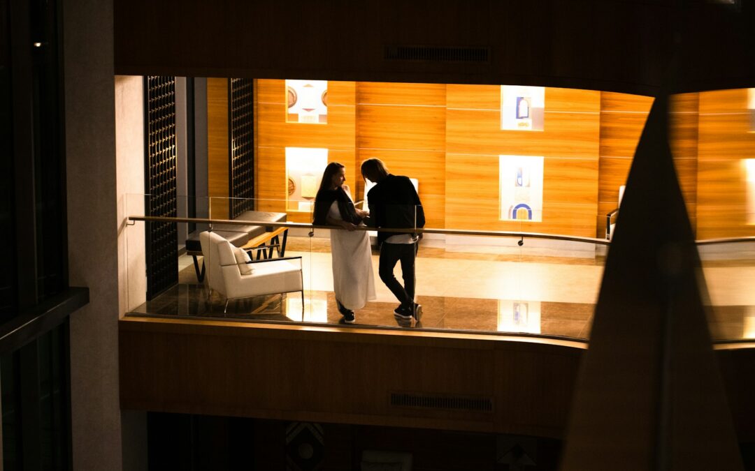 a man and a woman standing on a balcony at night