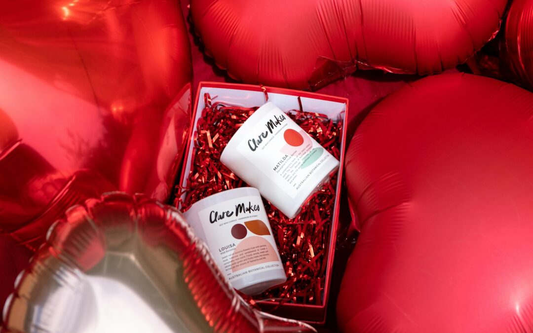 a bunch of red balloons and a cup of cream